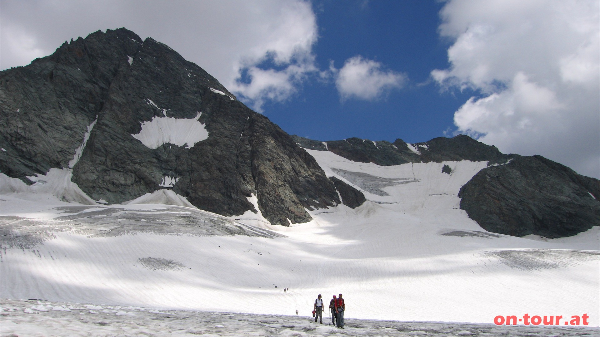 Auf der linken Seite des breiten, sanft ansteigenden Gletscher geht es bergauf. Im Norden, der mchtige Gipfelaufbau des Groglockners. Rechts die Adlersruhe und der Kampl. 